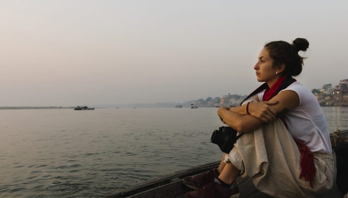 Photographer sitting on a boat on the River Ganges